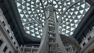 Documentation example: Atrium seen from below with a glass dome roof and a white steel tower Atrium with a glass dome roof, opens the full image