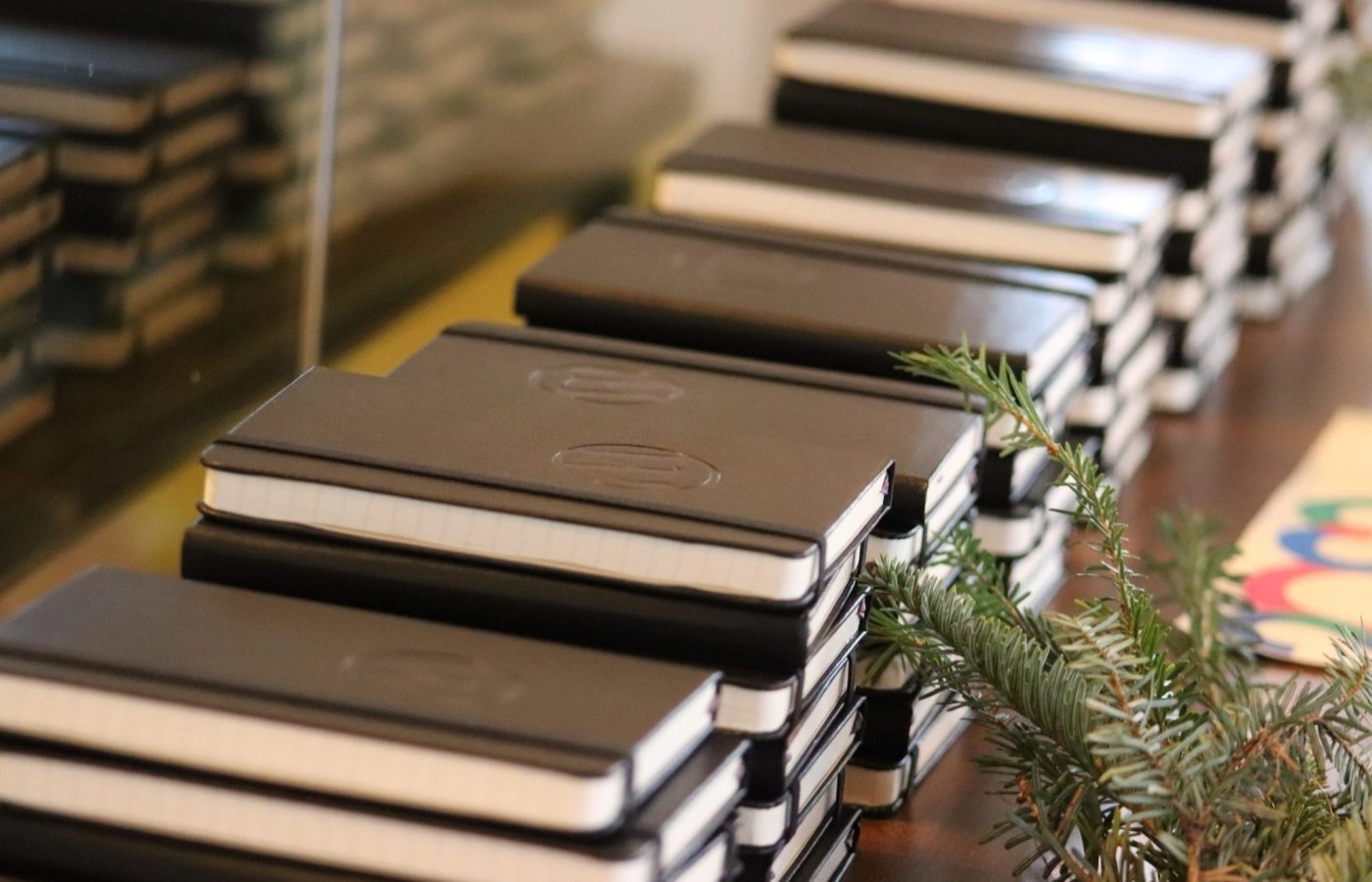 Stacks of black notebooks on a table